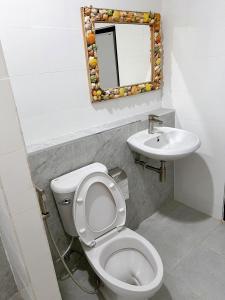a bathroom with a toilet and a sink at Tokyo Hotel in Nakhon Ratchasima