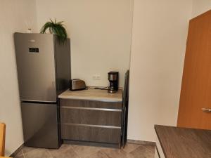 a kitchen with a stainless steel refrigerator and a counter at FeWo Bismarck 29 in Stendal