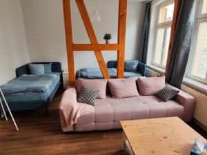 a living room with a couch and a bed at FeWo Bismarck 29 in Stendal