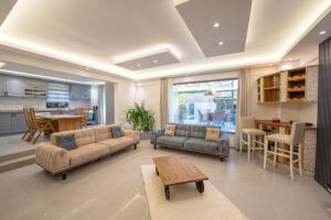 a living room with two couches and a table at Terra Kaya Villa in Kayakoy