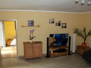 a living room with a flat screen tv on a wall at Child friendly Bungalow in B rgerende Rethwisch in Börgerende-Rethwisch