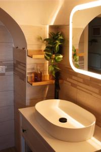 a bathroom with a white sink and a mirror at Villa Filou in Santa Lucia