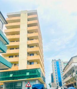 a tall building in the middle of a city at The central Heartbeat Haven Intercity in Dar es Salaam