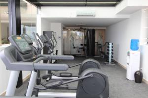 a gym with cardio equipment in a room at Hotel Poseidon in Manta