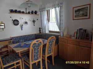 a dining room with a table and chairs and a window at Beautiful Apartment in Rerik with Garden near Sea in Rerik