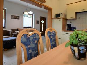 a kitchen and living room with a table and chairs at Beautiful Apartment in Rerik with Garden near Sea in Rerik