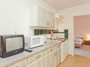 uma cozinha com uma televisão sentada num balcão em Luxurious Apartment in Heubach Germany in the Forest em Fehrenbach