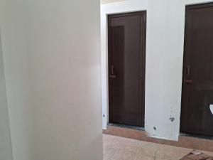 two doors in a room with white walls at Royal homes a3 in Kushālnagar