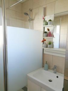 une salle de bain blanche avec un lavabo et un miroir dans l'établissement Spacieux appartement 90m2 4 chambres, proche mer, climatisation, tout confort, à Toulon