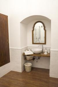 a bathroom with a sink and a mirror at La Casa del Fabbro in Troina