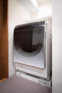 a television sitting on a stand in a room at MANGA ART HOTEL, BAKUROCHO in Tokyo