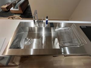 a stainless steel kitchen sink with a faucet at MANGA ART HOTEL, BAKUROCHO in Tokyo