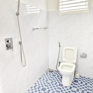 a bathroom with a toilet and a shower at Mamma Mia Villa and Cafeteria in Unawatuna