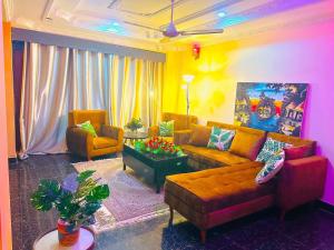 a living room with a couch and two chairs at Downtown Dreamspace City - 3 bedrooms in Dar es Salaam