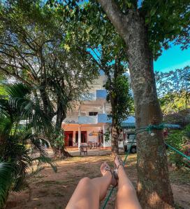 a woman with her feet chained to a tree at Pleasure Island Holiday Home in Dambulla
