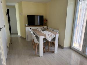 a dining room table with chairs and a television at Casa José Morella in Morella