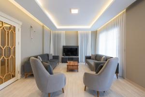 a living room with two couches and a tv at Villa Tutar 1 Marmaris Daily Weekly Rentals in Muğla