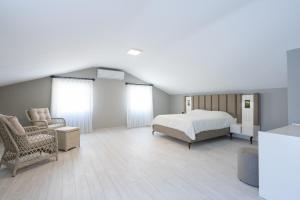 a bedroom with a bed and a couch and a chair at Villa Tutar 1 Marmaris Daily Weekly Rentals in Muğla +22 photos