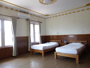 Säng eller sängar i ett rum på Hotel Suva
