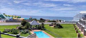 a view of a resort with a pool and a playground at De Valle 37 in Mossel Bay