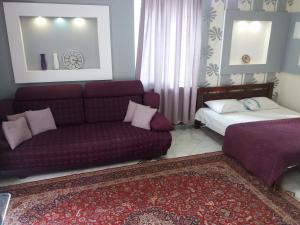 een woonkamer met een bank en een bed bij Apartment on 8 Marta in Nikolayev