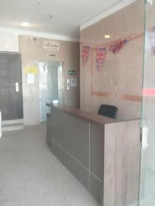 an office lobby with a reception desk and a door at دار الرضا Dar Al Reda in Al Madinah