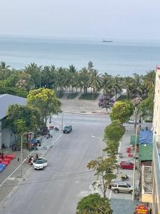 an aerial view of a street with palm trees and the ocean at Khách sạn Sơn Hiền Cửa Lò in Cửa Lò