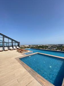 a swimming pool on the roof of a building at Kass Towers, Studio Apartment in Accra