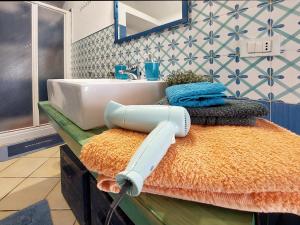 a hair dryer sitting on a counter in a bathroom at Forio Family Home in Ischia +24 photos