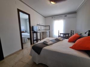 A bed or beds in a room at Victoria Hotel