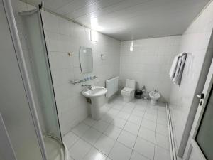 a bathroom with a sink and a toilet at Hostel Premium Tashkent in Tashkent