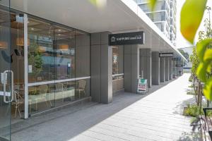 a store front of a building with glass windows at Sunshine 2 Bed home in Olympic Park in Sydney