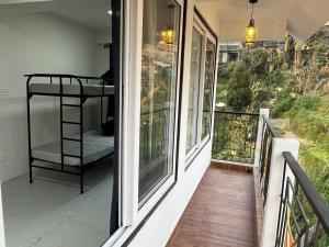 a balcony with a bunk bed on the side of a house at The Breeze Villa Complimentary Nature Walk with Kanchenjunga view in Darjeeling