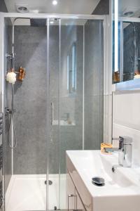 a bathroom with a shower and a white sink at Luxury Town House in Tavistock Sleeps 8 in Tavistock