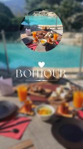 a table with plates of food and a view of the ocean at Auberge Du Roua in Argel&egrave;s-sur-Mer