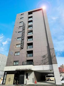 a building with a sign on the side of it at Hotel Classe Stay Sapporo in Sapporo