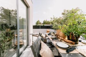 a dining room with a table on a balcony at Domina in Vodice