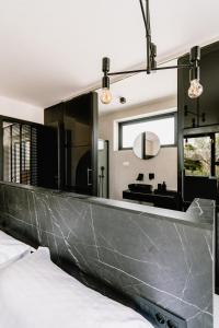 a bedroom with a large mirror above a bed at Domina in Vodice
