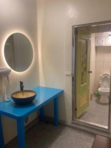 a bathroom with a bowl sink on a blue table at 夏綠房 in Fengyuan