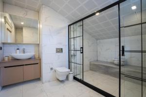 a bathroom with a shower and a toilet and a sink at Villa Tutar 2 in Marmaris