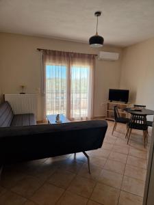 a living room with a pool table and a couch at Villa Keramidi in Limenaria +17 photos