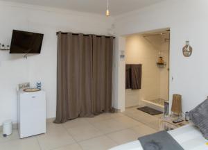 a bathroom with a shower curtain in a room at The Little Gem in Clanwilliam