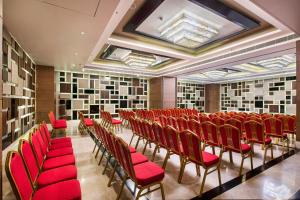 a conference room with red chairs and records at Hotel Satkar Grande in Thane