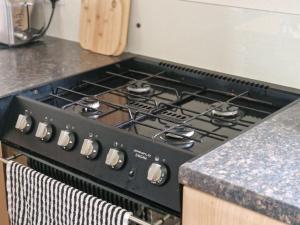 a black stove top oven in a kitchen at Plot 203 paris in Rhyl
