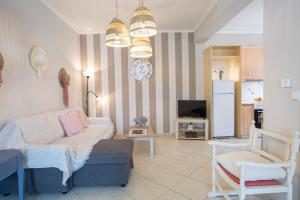 a living room with a couch and a tv at Levanda Cozy Apartments in Lefkada