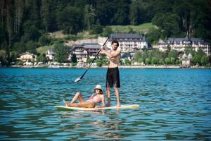 a man and a woman on a paddle board in the water at Getreidegassen Appartements in Salzburg