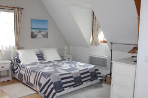 a bedroom with a bed with a black and white blanket at B&B DeValpierre adult only in Glanville