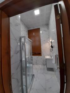 a bathroom with a glass shower and a sink at VE HOTELS KAPADOKYA in Nevşehir