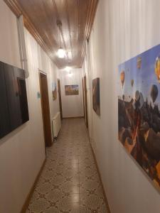 a hallway with paintings on the walls of a building at VE HOTELS KAPADOKYA in Nevşehir