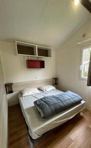a bedroom with a large bed in a room at VeniseOuest Hôtellerie de Plein Air in La Ferté-Bernard